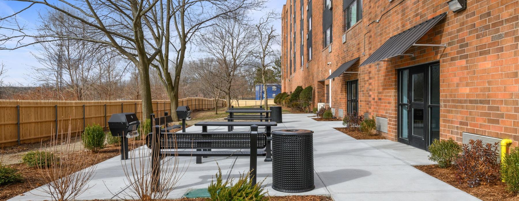 a brick building with a fence and a walkway